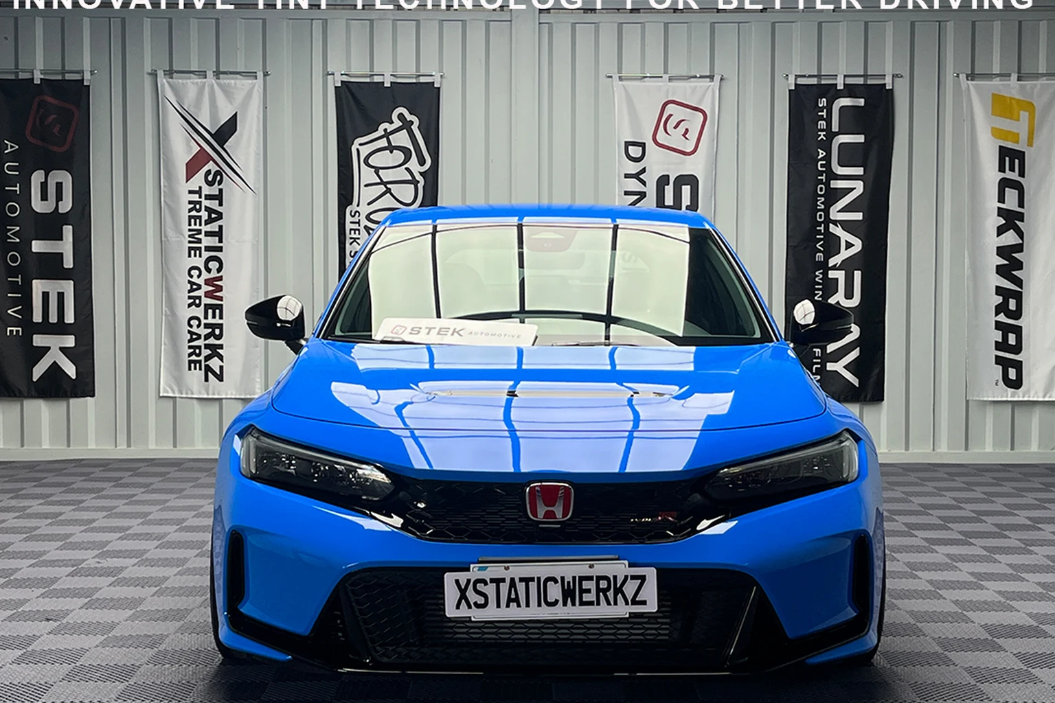 Blue XstaticWerkz sedan showcasing STEK automotive window tint